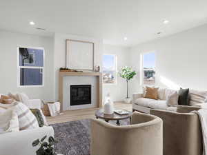 Living room featuring hardwood / wood-style flooring and a tiled fireplace