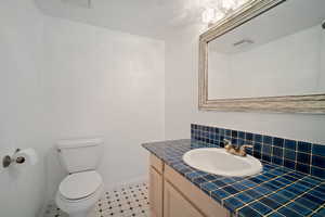 Bathroom with tasteful backsplash, vanity, and toilet