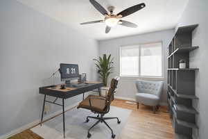 Office area with ceiling fan and light hardwood / wood-style flooring