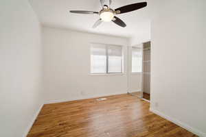 Spare room with ceiling fan and hardwood / wood-style floors