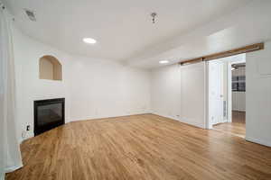 Unfurnished living room featuring light hardwood / wood-style floors