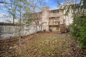 View of yard with a balcony