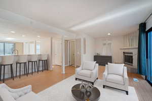 Living room with light hardwood / wood-style flooring and sink