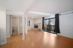 Unfurnished living room with a fireplace and light hardwood / wood-style flooring