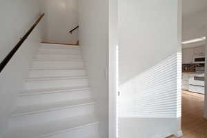 Stairway with hardwood / wood-style flooring