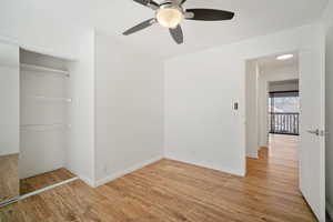 Unfurnished bedroom featuring ceiling fan, light wood-type flooring, and a closet