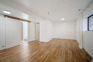 Interior space with hardwood / wood-style floors and a barn door