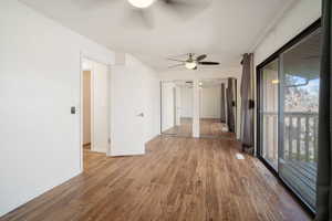 Spare room with hardwood / wood-style floors and ceiling fan