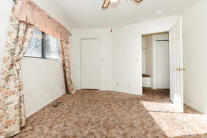 Unfurnished bedroom with carpet flooring, ceiling fan, and a closet