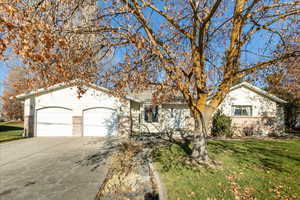 Single story home featuring a front lawn and a garage