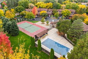 Bird's eye view of tennis court, pool, and clubhouse