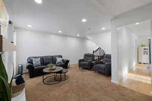 Carpeted living room featuring can lighting