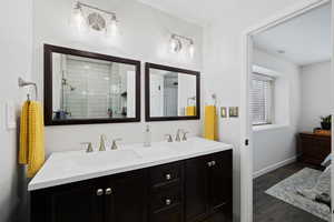 Primary Bathroom featuring tile floors, double vanity, and walk in shower