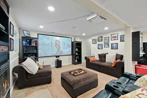 Living room with light carpet floors, projector and screen