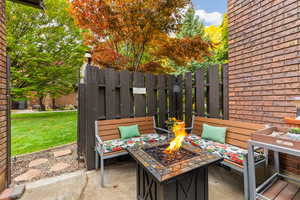 View of front patio featuring an outdoor fire pit