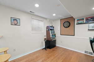 Game room space with hardwood floors