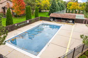 View of swimming pool with a lawn