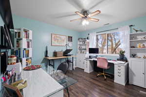 Spare bedroom used as office space featuring ceiling fan and dark wood-style floors