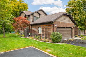 View of front facade with a front yard and a garage