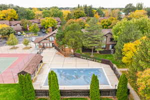 Bird's eye view of tennis court, pool, and clubhouse