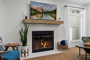 Interior space with a fireplace, carpet floors, and ornamental molding