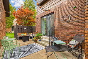 View of front patio featuring an outdoor fire pit