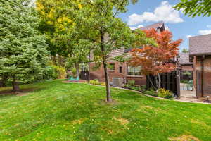 View of yard with flower beds and central AC unit