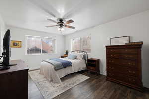 Primary Bedroom featuring ceiling fan, dark wood-style flooring and mountain views