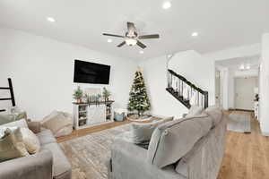 Living room featuring ceiling fan and light hardwood / wood-style floors