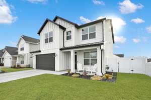 Modern farmhouse with a garage and a front lawn