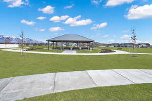 View of community with a lawn, a mountain view, and a gazebo