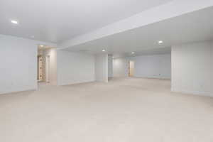 Basement featuring light carpet