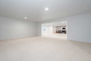 Unfurnished living room with light carpet