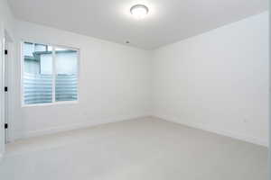 Spare room with light carpet and plenty of natural light