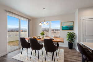 Dining room with an inviting chandelier, light wood-type flooring, and a mountain view