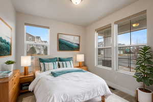 Bedroom with light wood-type flooring and multiple windows