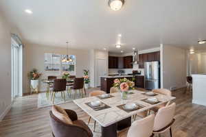 Dining room featuring an inviting chandelier and light wood-type flooring