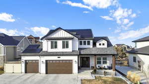 Modern inspired farmhouse with a garage and solar panels