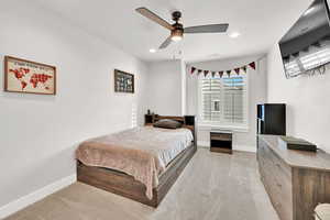 Carpeted bedroom with ceiling fan