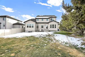 Snow covered house with a yard, cooling unit, and solar panels