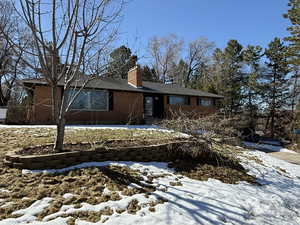 Exterior space with brick siding and a chimney