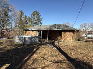 Rear view of house with a fenced in pool and brick siding