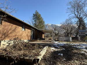 Exterior space featuring entry steps, a mountain view, an attached carport, and brick siding