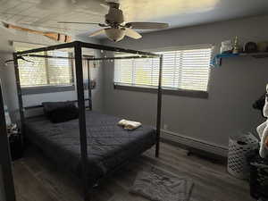 Bedroom with ceiling fan and wood finished floors