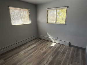 Unfurnished room featuring baseboards and wood finished floors