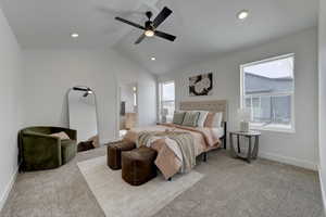 Carpeted Primary bedroom featuring ceiling fan, lofted ceiling, and connected bathroom