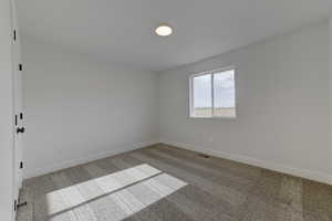Unfurnished room with carpet floors