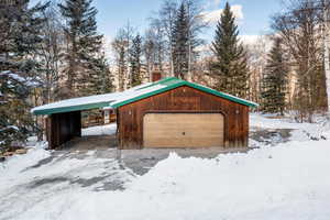 Exterior space with a garage and a carport