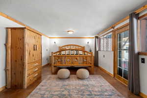 Bedroom featuring a textured ceiling and crown molding