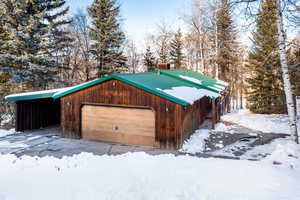 View of front of property with an outdoor structure and a garage